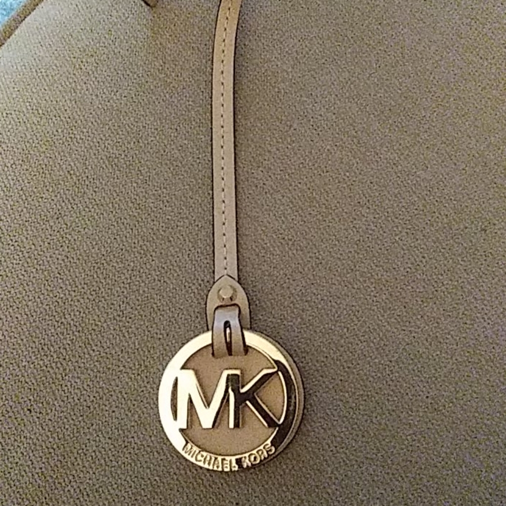 NWOT Michael Kors hangtag. Firm price $16 each .  No bundle discounts..